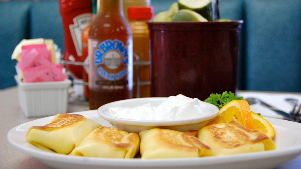 Blintzes (4) · Our very own. Blueberry, cheese, or cherry cheese. Served with sour cream and preserves.