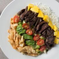 Thai Steak And Noodle Salad · Chow mein noodles with flank steak, cabbage, romaine lettuce, avocado, mango, tomatoes, pean...