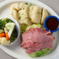 Corned Beef And Cabbage · A mound of sliced Corned Beef served with a Quarter Cabbage and Boiled Potatoes
