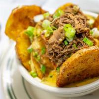 Loaded Thick Chips · Poblano-beer cheese, smoked pulled pork, green onions.