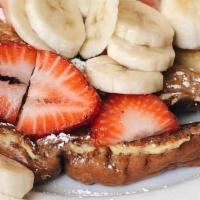 French Toast · Served with fresh bananas, strawberries and powdered sugar.