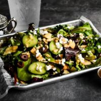 Persian Garden Salad · Fresh mix of organic greens, persian pomegranate-olive- feta dressing, cherry tomatoes, pers...