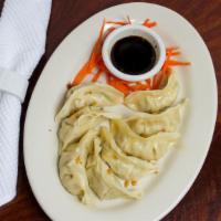 Dumpling (9 Pcs) · Pan fried with ground chicken and mixed vegetables served with chef's sauce.