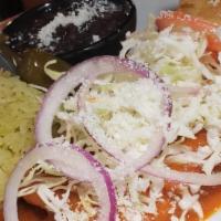 Enchiladas De Michoacan · Vegetarian. Cotija cheese enchiladas garnished with cabbage served with cilantro rice, beans...