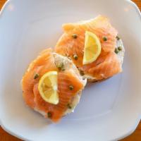 Lox Nest Bagel · Cream cheese, capers, salmon lox, and a lemon wedge on  toasted bagel.