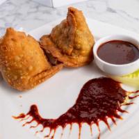 Samosas · Two crispy stuffed pastries seasoned with mild spices and deep-fried.