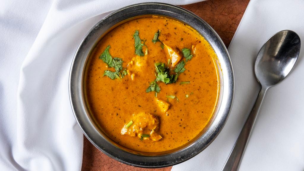 Chicken Tikka Masala · Boneless chicken roasted in a clay oven, finished with a delicious blend of creamed tomato curry, and spices. Served with imported basmati rice.