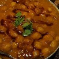 Channa Masala · Garbanzo beans in a tangy tomato, onion, and garlic curry sauce.