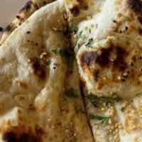Naan · All breads are baked fresh, on the interior all of the tandoor (clay oven).