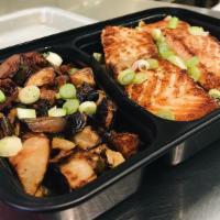 Salmon Bowl · Wild caught Norwegian salmon served with brown rice, roasted veggies and green onions.