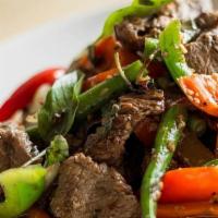 Blazing Basil · Tender beef stir fried with fresh basil leaves, green beans, onions, carrots, and bell peppe...