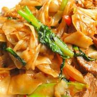Pad Kee Mow · Flat rice noodle stir-fried with spicy basil garlic sauce, bell peppers, tomatoes, sweet oni...