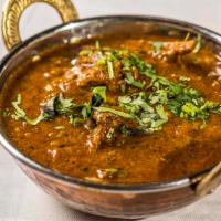Baigan Bhartha · Baked eggplant with spices. Comes with 2 rotis.