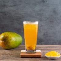 📍 Moonlight Mango · Mango star jelly and green mango bits in mango peach green tea.
