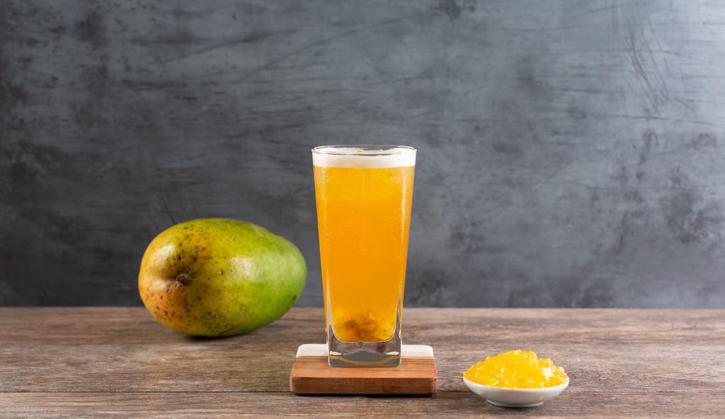 📍 Moonlight Mango · Mango star jelly and green mango bits in mango peach green tea.