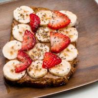 Almond Butter Toast · 2 slices of multigrain bread, almond butter topped with banana, strawberry and cinnamon honey.