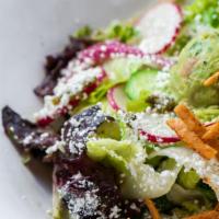 Baja Chop · Guac, radishes, cabbage, pickled onions, cotija cheese, tortilla strips, charred poblano dre...