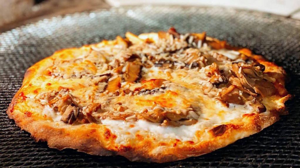 Mixed Mushroom · Japanese mushrooms, garlic butter, and soy sauce thin crust pizza.