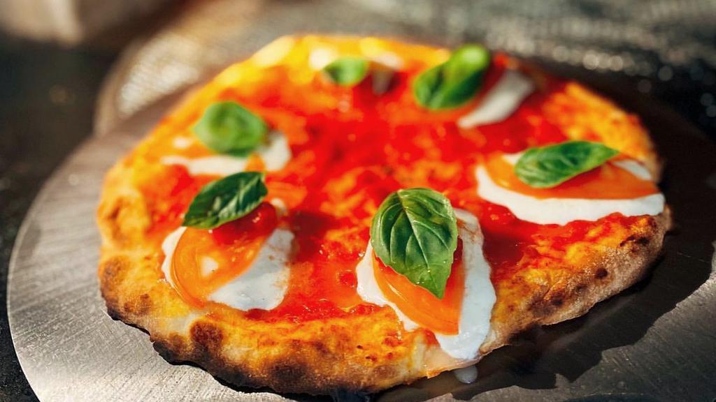 Margherita · Tomato sauce, fresh mozzarella, tomato, and basil.