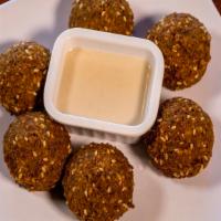 Falafel ( 6 ) · Vegan. Fresh ground chickpeas and our house blend of seasoning
deep fried to perfection.