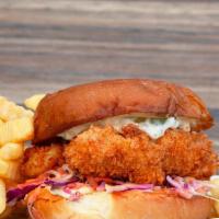 Crispy Fish Sandwich & Fries · Ale-battered wild pacific cod, shaved cabbage, pickles & tartar sauce.
