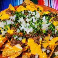 Beef Birria Nachos · Fresh corn tortilla chips, topped with Beef Birria, nacho cheese, jalapeños, red onions, cil...