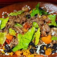 Beef Birria Bowl · Rice topped with your choice of birria beef, black beans, lettuce, tomato, onion, and salsa.