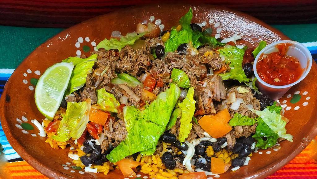 Beef Birria Bowl · Rice topped with your choice of birria beef, black beans, lettuce, tomato, onion, and salsa.
