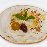 Labneh · Thick and creamy labneh (yogurt cheese) drizzled with olive oil garnished with aleppo pepper...