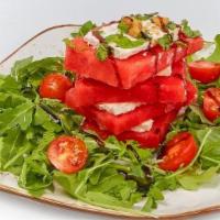 Feta Watermelon Salad · Garnished with mint, with pine nuts, heirloom tomatoes, basil, olive oil, balsamic glaze on ...