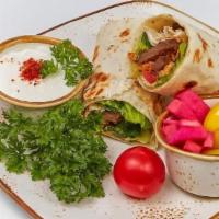 Shawarma Wrap · Wrapped with arugula, tomatoes, cucumber, parsley, tahini sauce. Side of pickled turnip, chi...