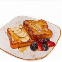 French Toast · Topped with banana and fresh berries, cinnamon and sugar powder.