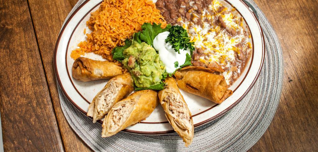 Chingolingas · A flaky pastry filled with chicken served with rice and beans, garnished with guacamole and sour cream. Absolutely delicious!