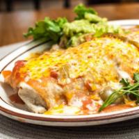 Azteca Burrito · Filled with shredded chicken, beef or Chile verde and beans. Smothered with salsa ranchera a...