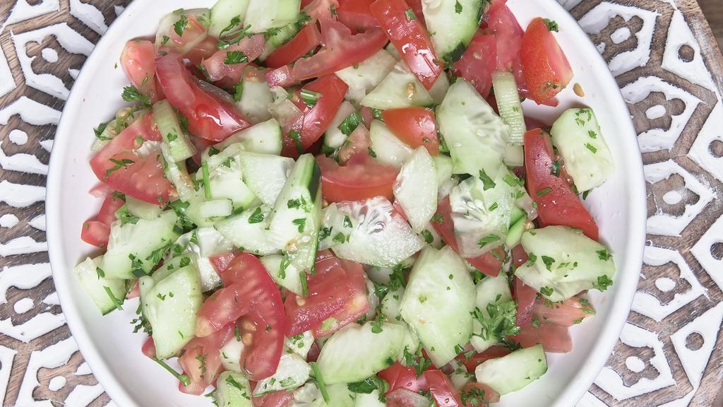 Shirazi Salad · Chopped tomato, cucumber, mint, onion, olive oil, parsley, and fresh lemon juice.