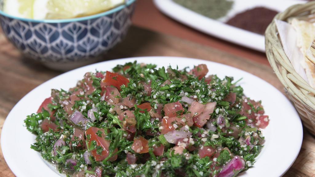 Tabouleh Salad · Finely chopped parsley, cracked wheat, tomato, lemon juice, mint and olive oil.