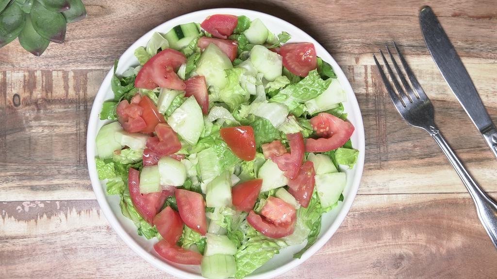 House Salad · Lettuce, tomato, cucumber with a fresh lemon juice, olive oil, and mint.