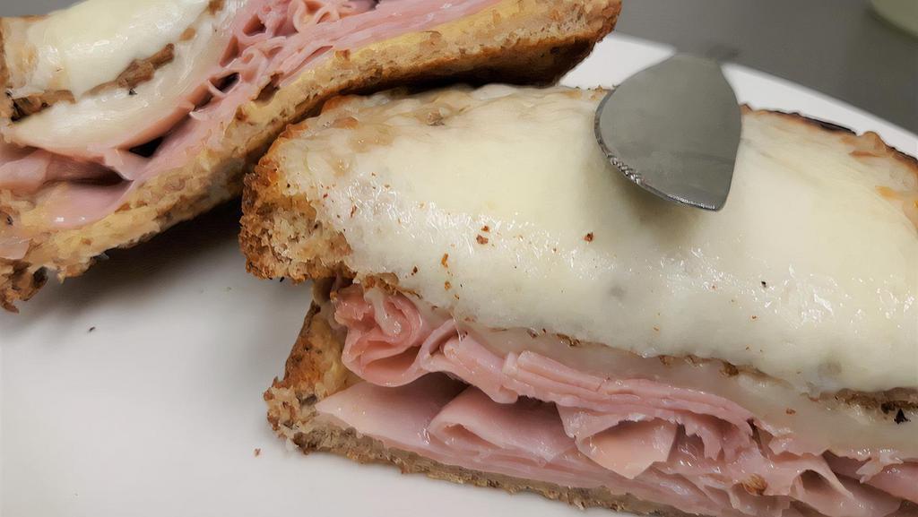 Croque Monsieur · French version of a toasted ham and Swiss cheese sandwich with dijon mustard.