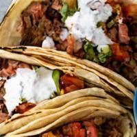 Loaded Carne Asada Taco · Carne asada with cabbage slaw, pico de gallo, guacamole, cotija, and cilantro loaded into a ...