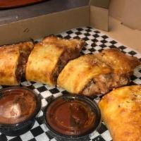 Calzones · Baked crust and choice of one or two toppings with mozzarella, pizza sauce topped with garli...