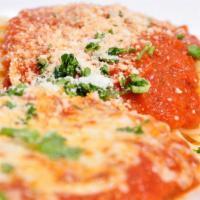 Chicken Parmesan · Breaded chicken breast topped with mozzarella cheese and marinara sauce served with a side o...