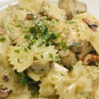 Chicken Bowtie · Bowtie pasta with grilled chicken, Mushrooms and sundried tomatoes in roasted garlic cream s...