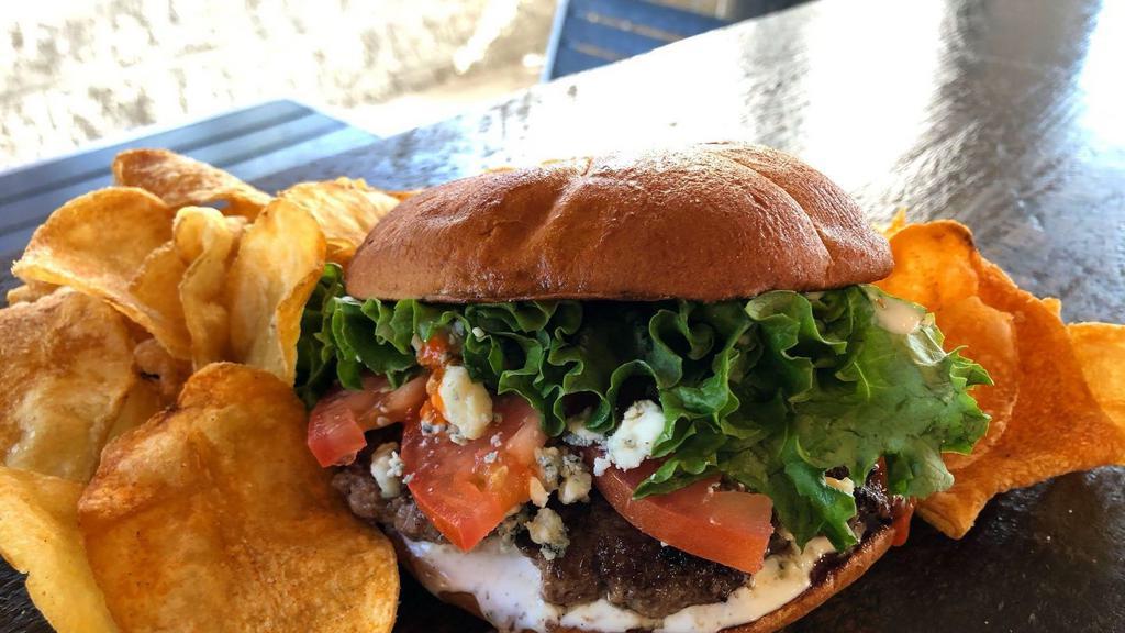 Buffalo Bleu Burger · Smashed ground beef patty with ranch dressing, zippy buffalo sauce, bleu cheese crumbles, lettuce and tomato on a toasted Hawaiian bun. Served with russet potato chips.