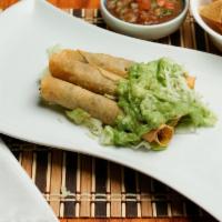 Taquitos Con Guacamole · Three rolled shredded beef, chicken or potato taquitos topped with guacamole and cheese.