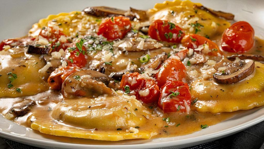 Ravioli Di Bello · Portobello ravioli, crimini mushrooms, roasted grape tomatoes, Grana Padano Zanetti, fresh thyme, brown butter sauce.