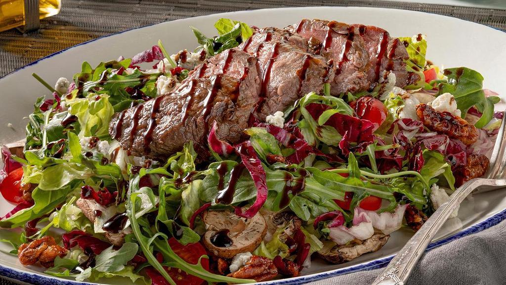 Grilled Steak Salad* · Sliced tenderloin, tomatoes, gorgonzola, mushrooms, candied pecans, creamy horseradish, balsamic glaze