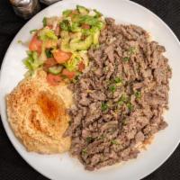 Beef Shawarma · Marinated grilled beef. Served with rice, two sides, pita bread, and sauce.