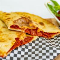 Pizza Calzone · Medium size Calzone with Mozzarella and Peperoni's and red sauce on the side.