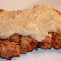 Country Fried Steak & Eggs · Delicious country fried steak topped with country gravy served with 3 extra large eggs, choi...