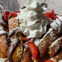 Nutella French Toast With Fruits · 3 slices of french toast smothered with Nutella, strawberries, and banana.